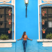 girl-in-front-of-blue-wall-with-flowers-mexico